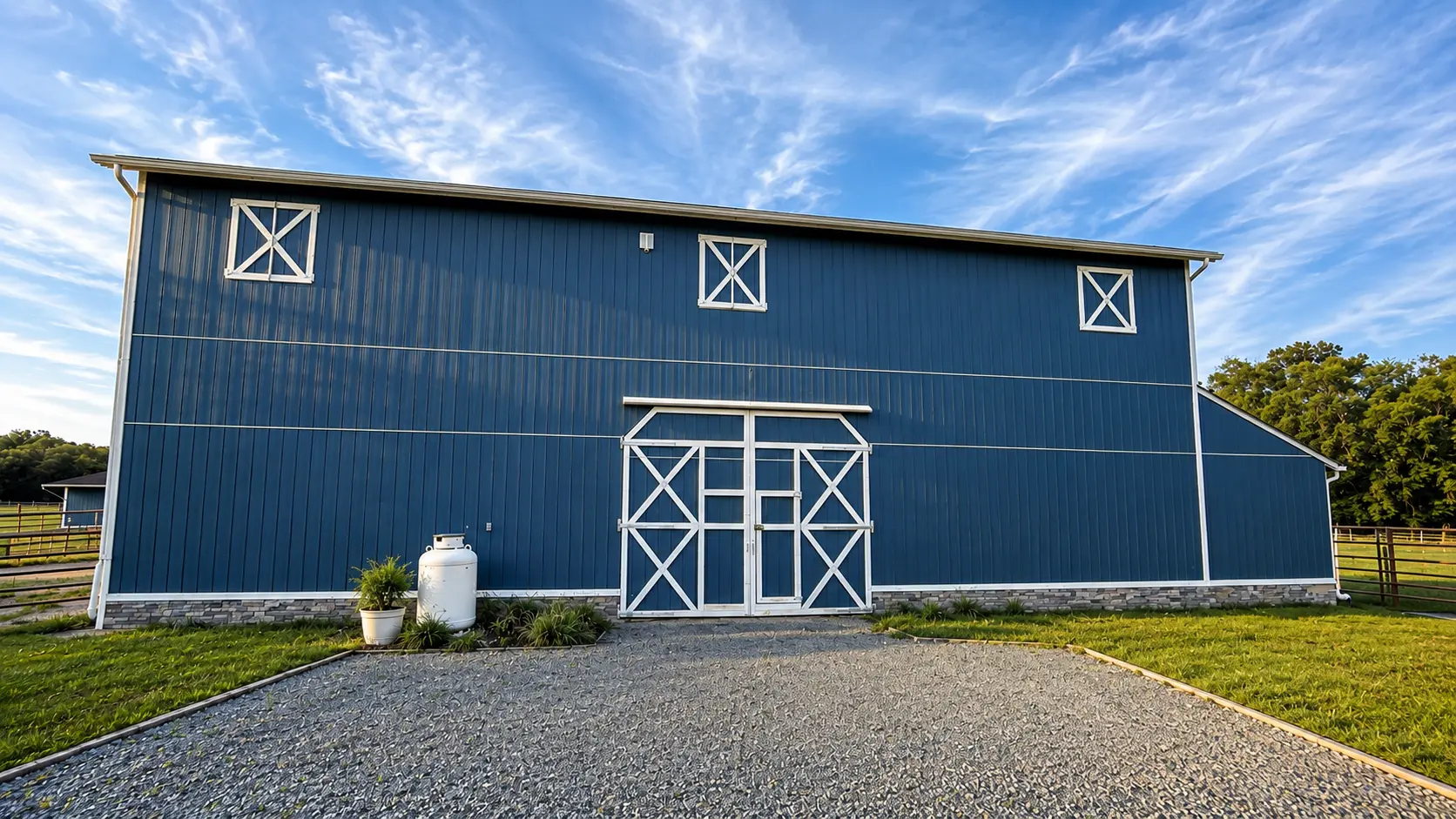 The blue barn across the green pasture